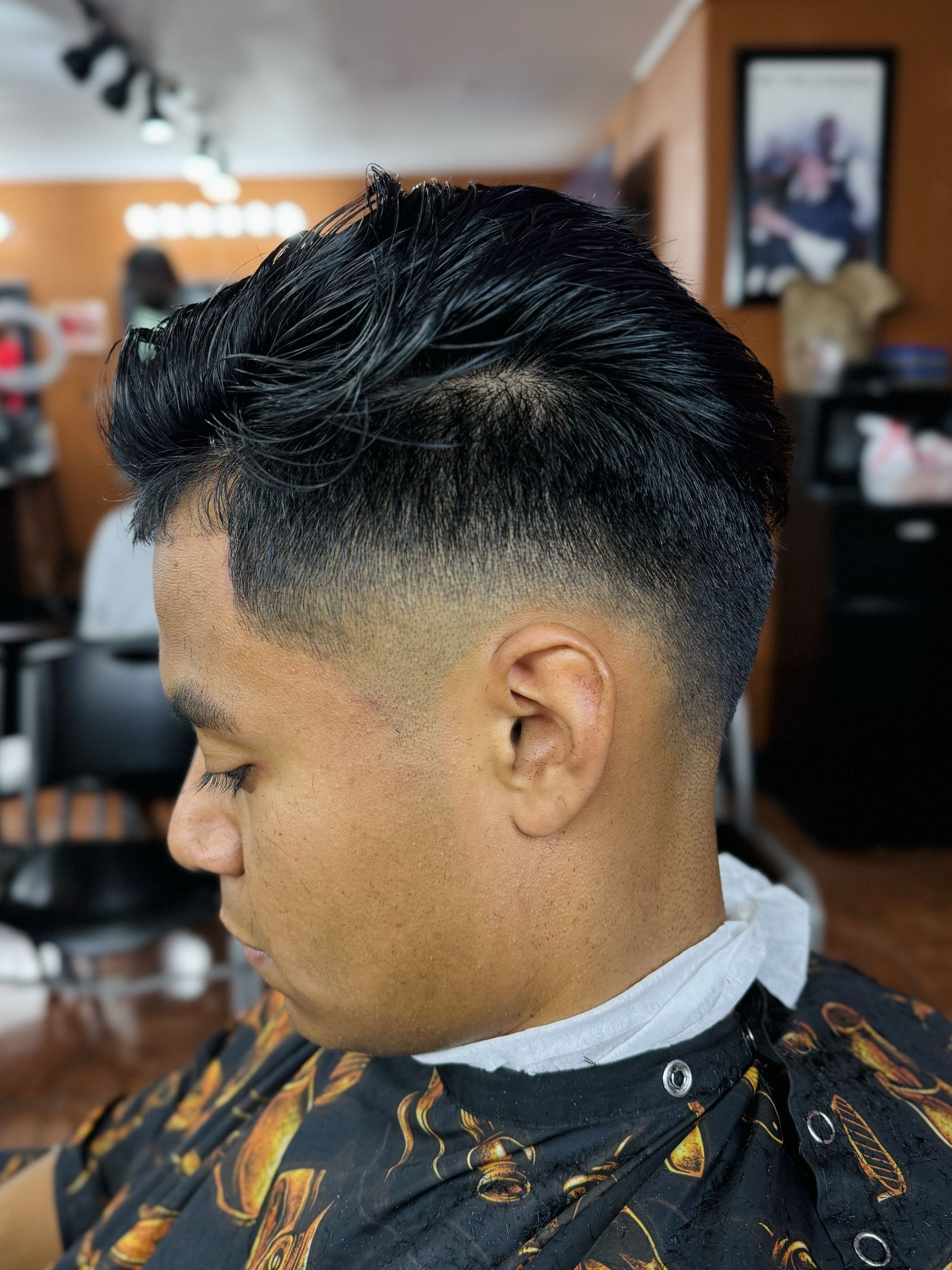 Textured quiff with mid drop fade by Big Shawn — Rocky's Primetime Barbershop Atlanta