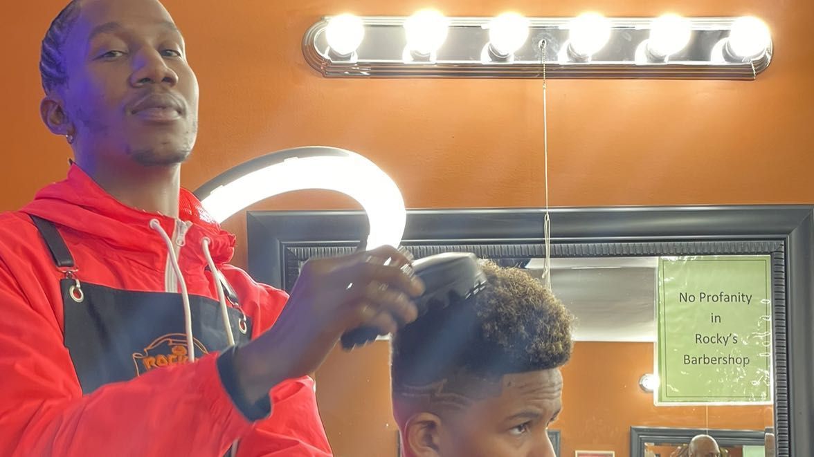 Inside Rocky's Primetime Barbershop — barber styling a client in Buckhead Atlanta