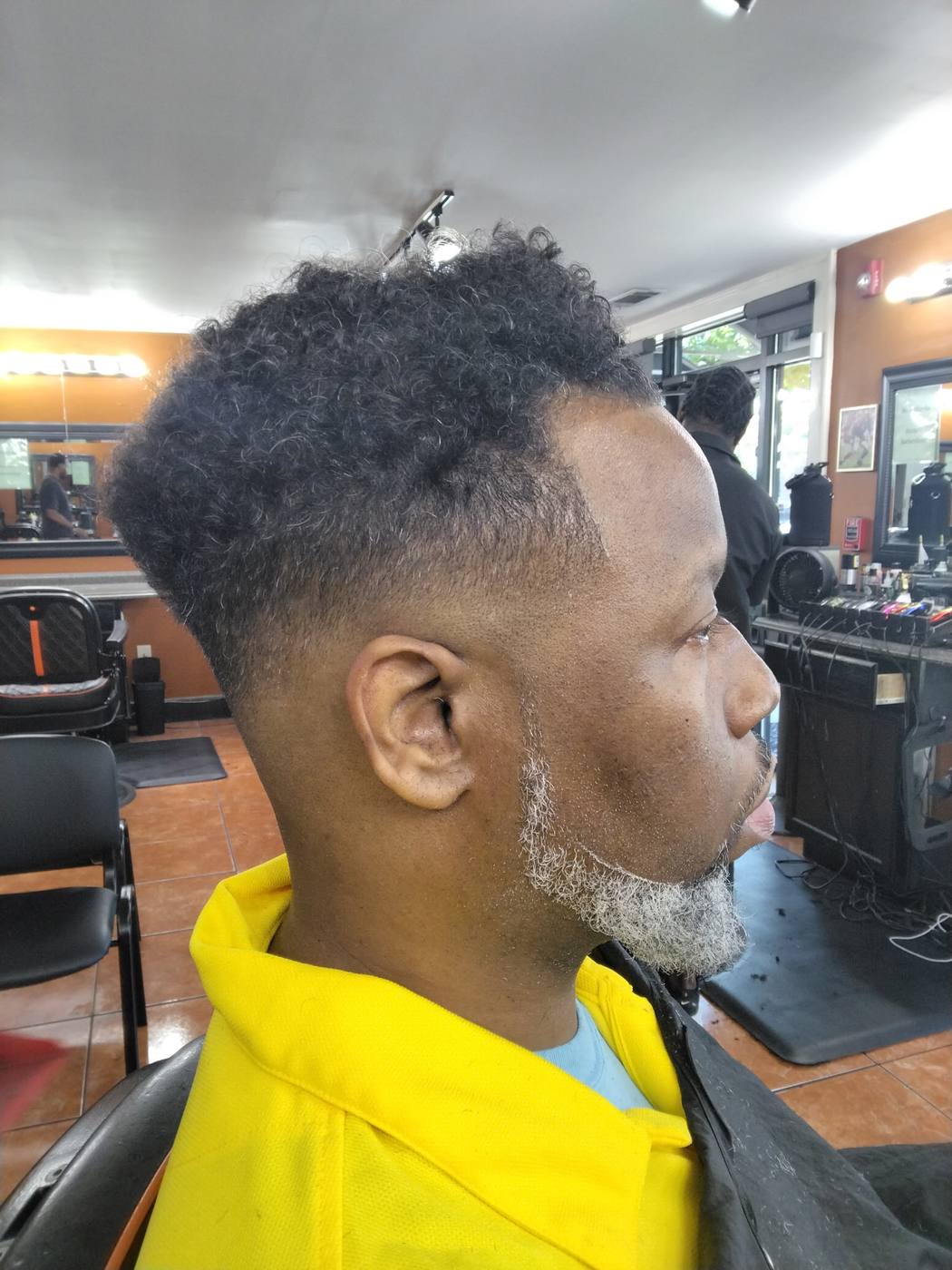 Curly top with a drop fade and shaped grey beard by Cam — Rocky's Primetime Barbershop, Buckhead Atlanta