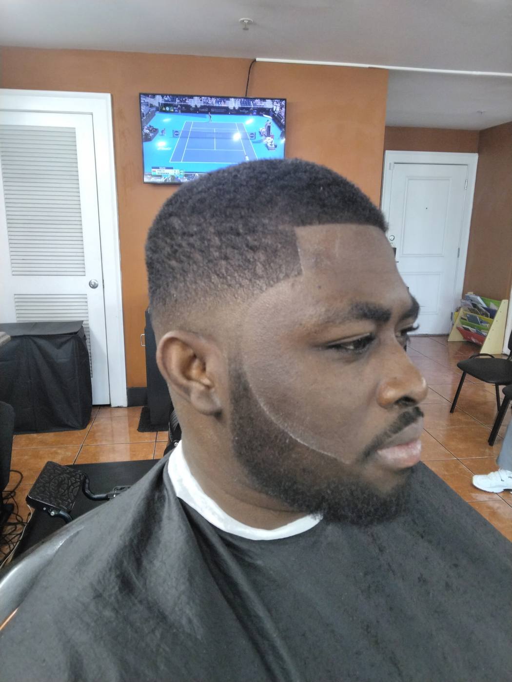 Low fade with a sharp lineup and full beard blend by Cam — Rocky's Primetime Barbershop in Atlanta
