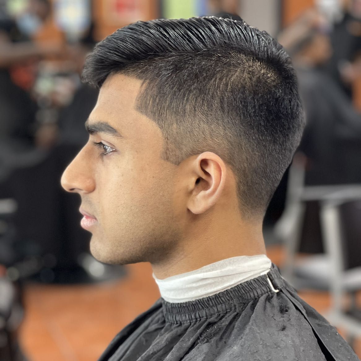 Slick pompadour with taper fade by MJ — Rocky's Primetime Barbershop Atlanta