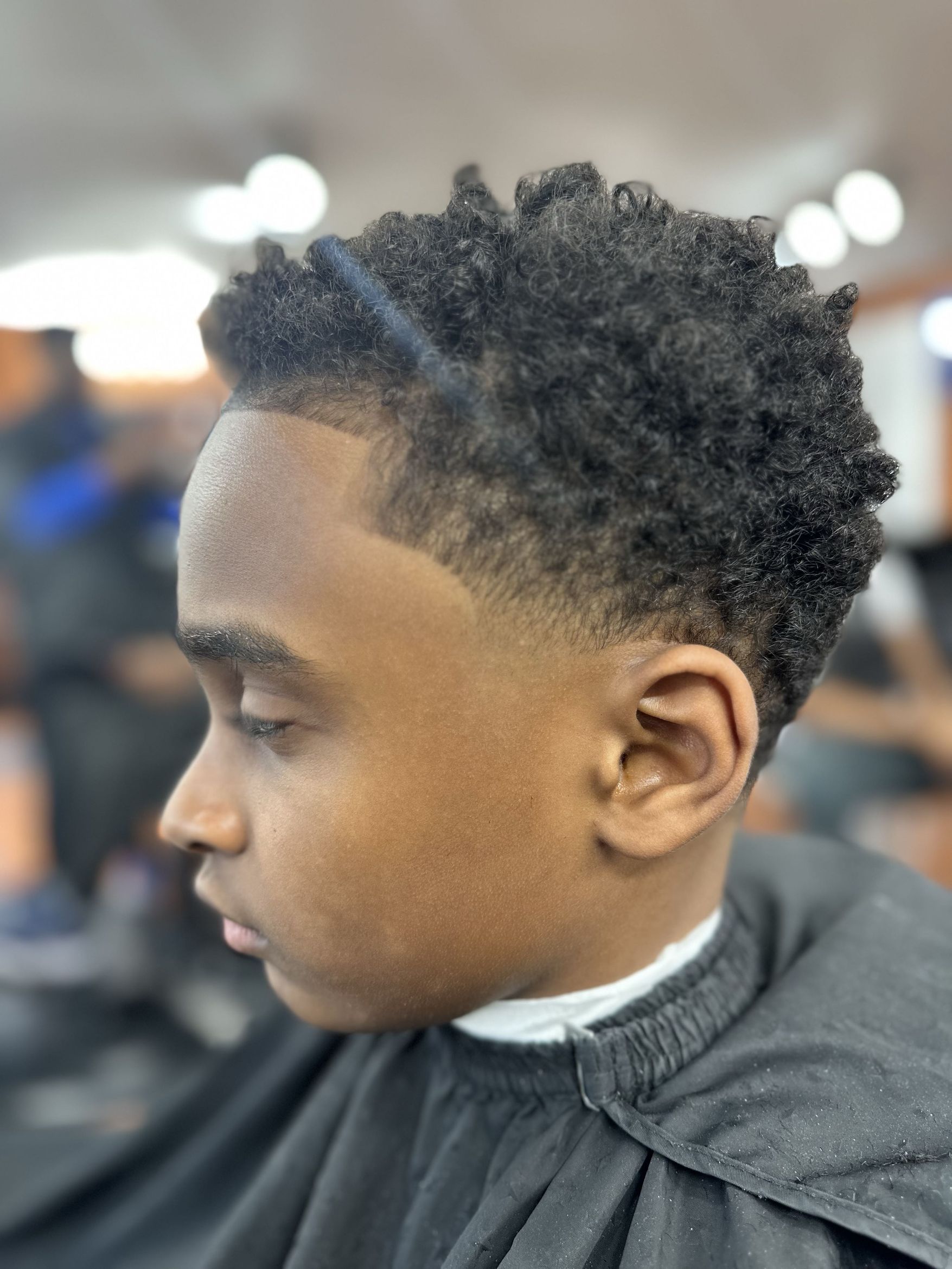 Kids curly top with taper fade by MJ — Rocky's Primetime Barbershop Atlanta
