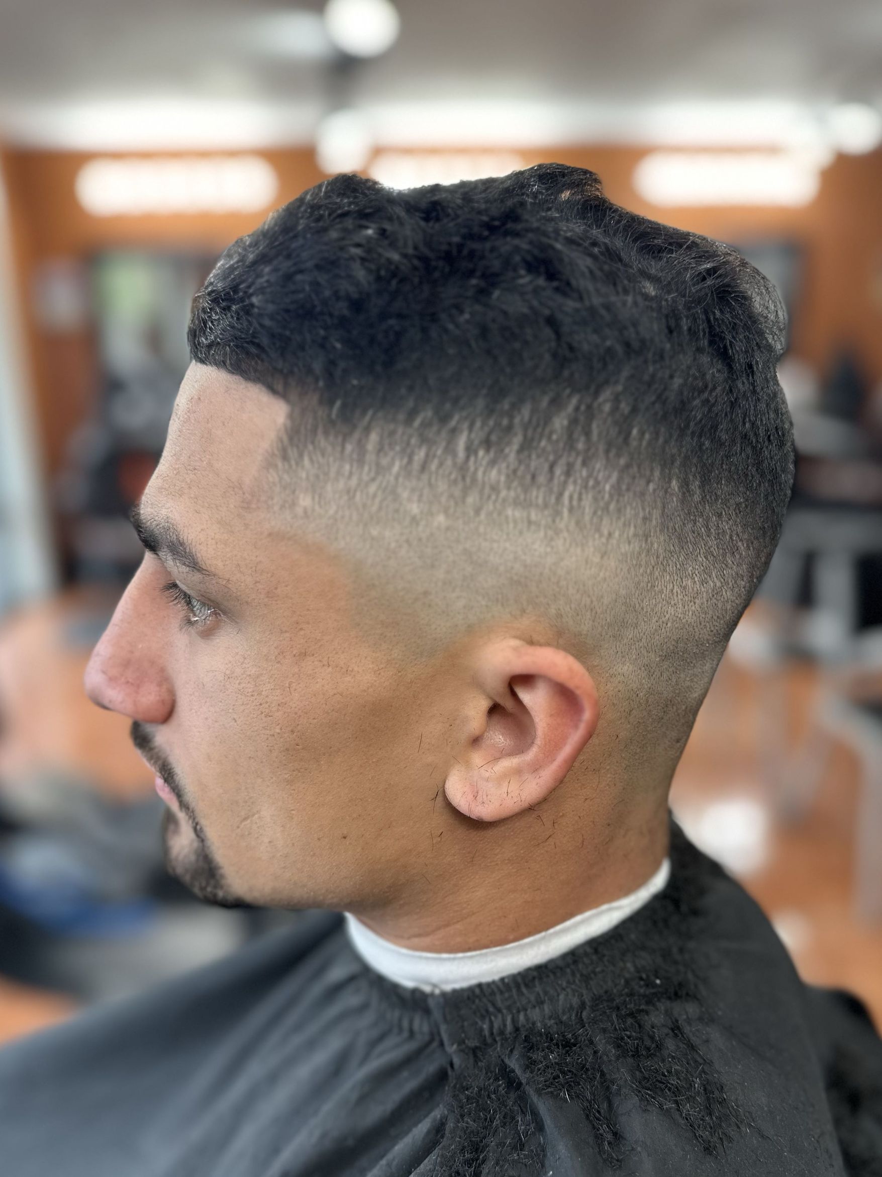Textured crop with high skin fade by MJ — Rocky's Primetime Barbershop Atlanta