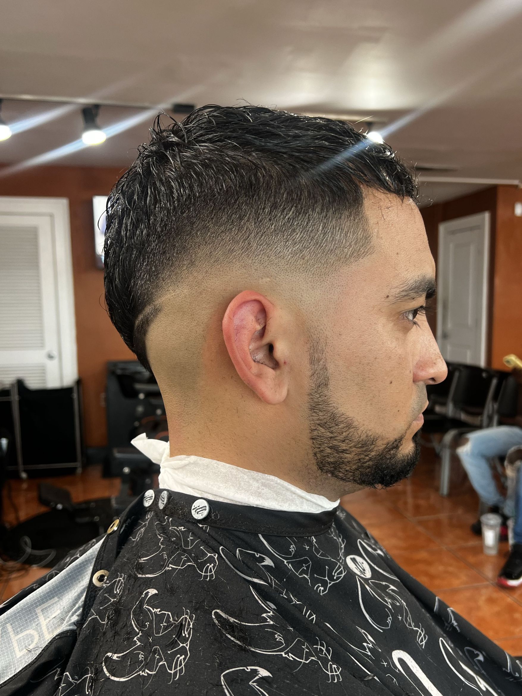 Burst fade with textured top and beard by Rich — Rocky's Primetime Barbershop Atlanta