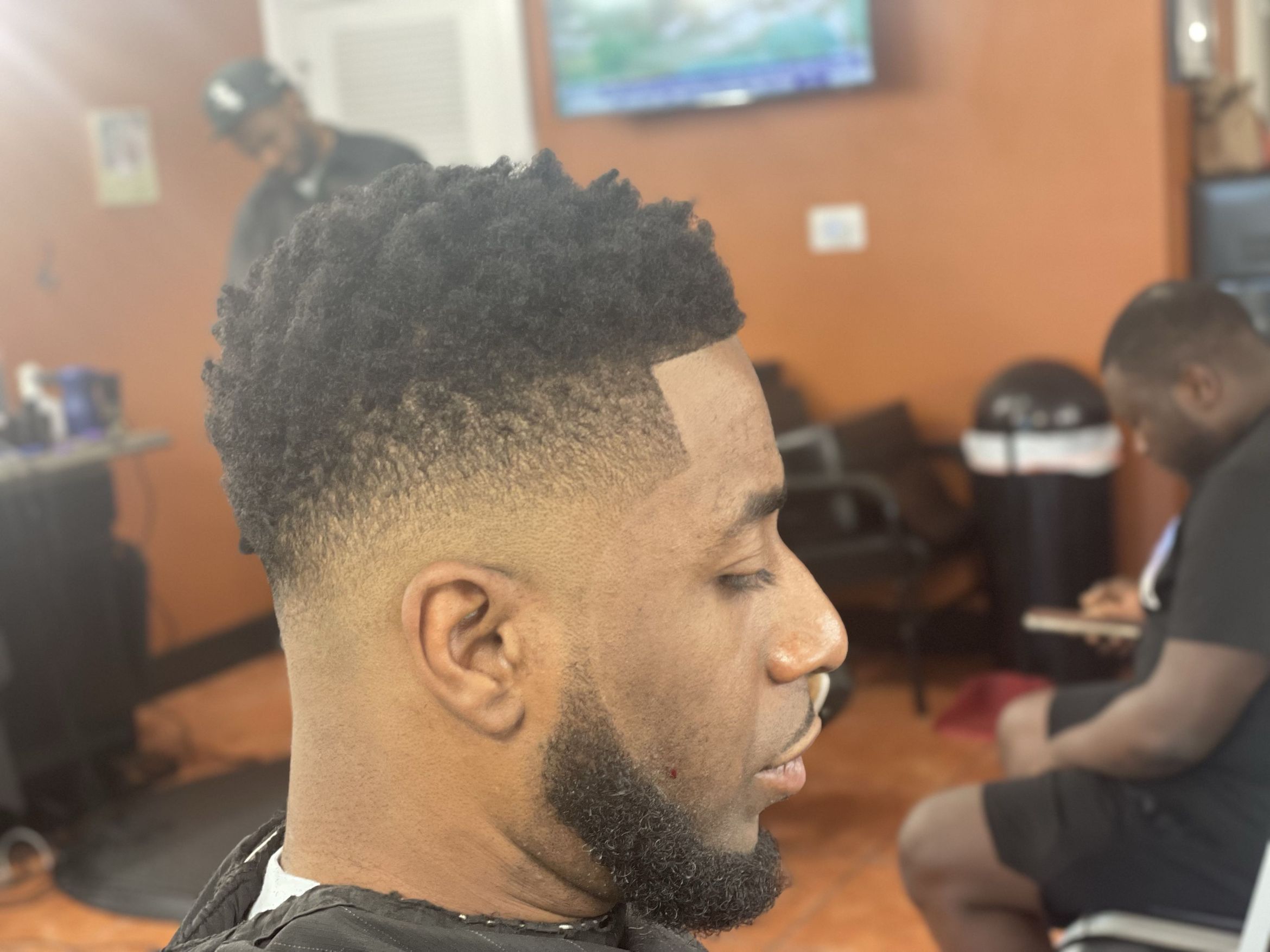 Textured top with taper fade and beard by Rocky — Rocky's Primetime Barbershop Atlanta
